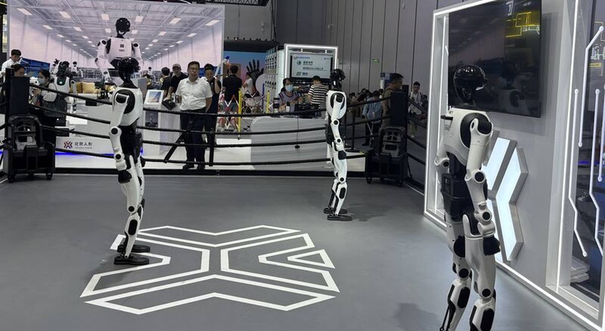 Humanoid robots walking a show floor at the World Robot Conference, Beijing